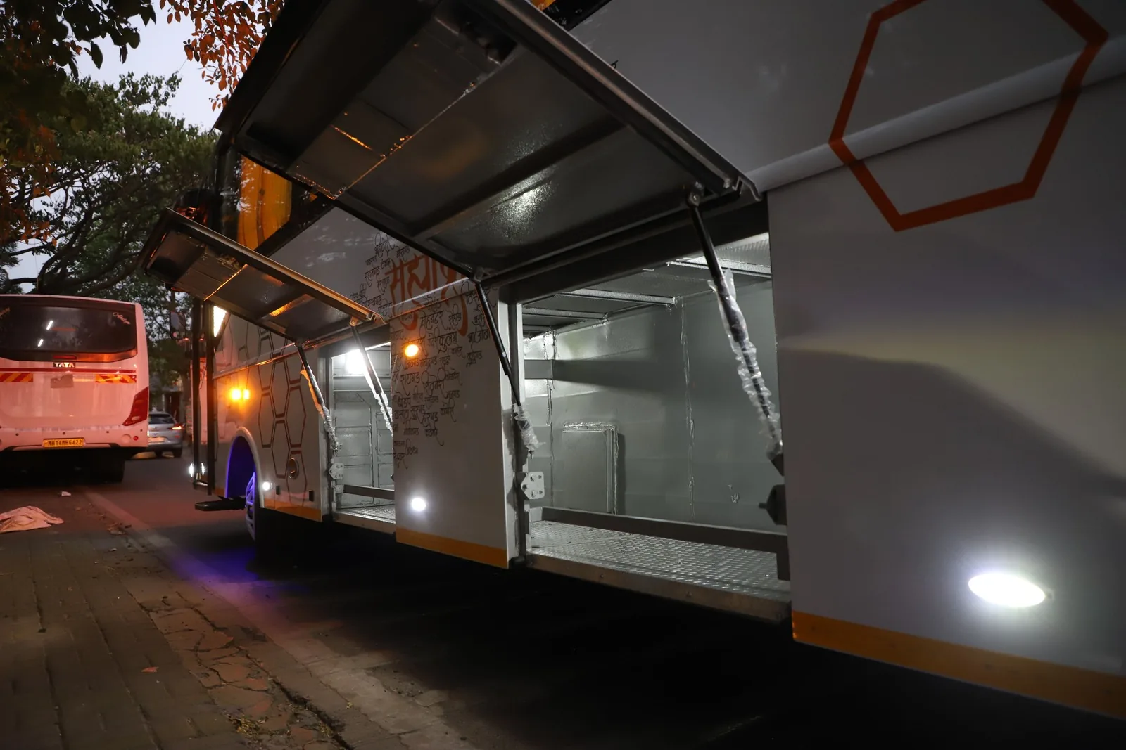 Bus side luggage compartment open showing luggage storage space